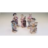 Five Meissen figurines, four with instruments, one holding grapes, painted with gold detail, all