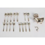 Multiple sets of silver hallmarked tea spoons, a napkin ring and a silver hallmarked sauce boat