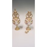 A pair of Royal Doulton lidded and two handled pots, with gilded and floral swag design, heights
