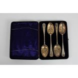 A set of four dessert spoons with fruit decoration in box with blue velvet lining. On line viewing