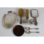 A selection of silverware to include a hallmarked tray with leaves and flowers decoration, a