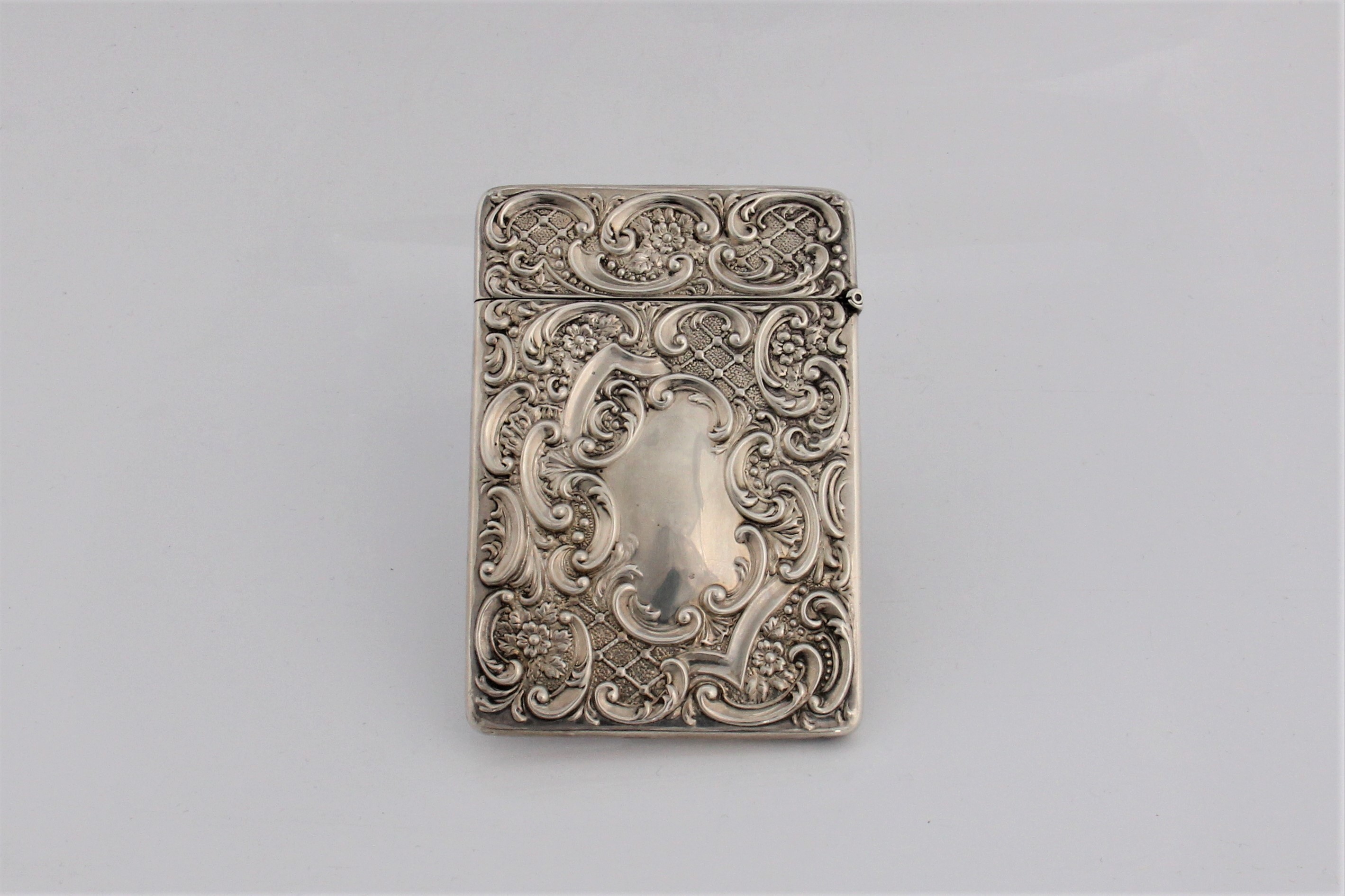 A silver card case with hinged lid