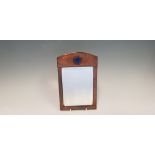 An Arts & Crafts copper hand beaten framed mirror with blue porcelain insert, 27cm x 17.5cm.