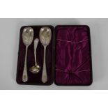 A serving set comprising with two large spoons, with engraved leaf scroll decoration in a purple