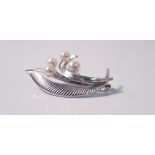 A Mikimoto pearl brooch, set with four variously sized pearls, smallest measuring approx. 5mm and