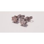 A pair of diamond stud earrings on white metal, each earring approx.0.33ct. On line viewing and