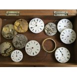 A box containing watch faces and other parts including Russell & Son, J.G. Graves, etc. On line