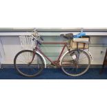 Pilgrims maroon painted bicycle with basket to front. IMPORTANT: Online viewing and bidding only.
