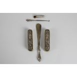 A selection of silver to include, a silver hallmarked shoe horn, two silver decorative clothes