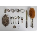 A collection of silverware to include, a hallmarked hair brush, a glass and silver decorative