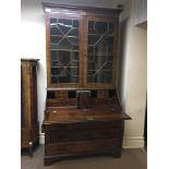 An early 19th century mahogany bureau bookcase with two glazed doors to top, four drawers to base