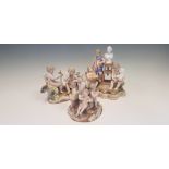 Three Meissen figurine groups, including two putti with armour, three putti with classical sculpture