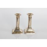 A pair of filled candlesticks