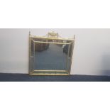 A modern gilt framed French style wall mirror with urn and swag to top. IMPORTANT: Online viewing