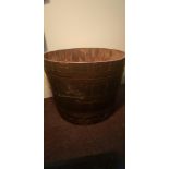 An oak large half metal bound wine barrel, diameter to top 84cm. IMPORTANT: Online viewing and