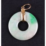 A green jadeite jade pi disc pendant, unmarked yellow metal mount, diameter approx. 2.5cm. On line