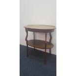 A mahogany late 19th century two tier occasional table on shaped legs and brass gallery back.