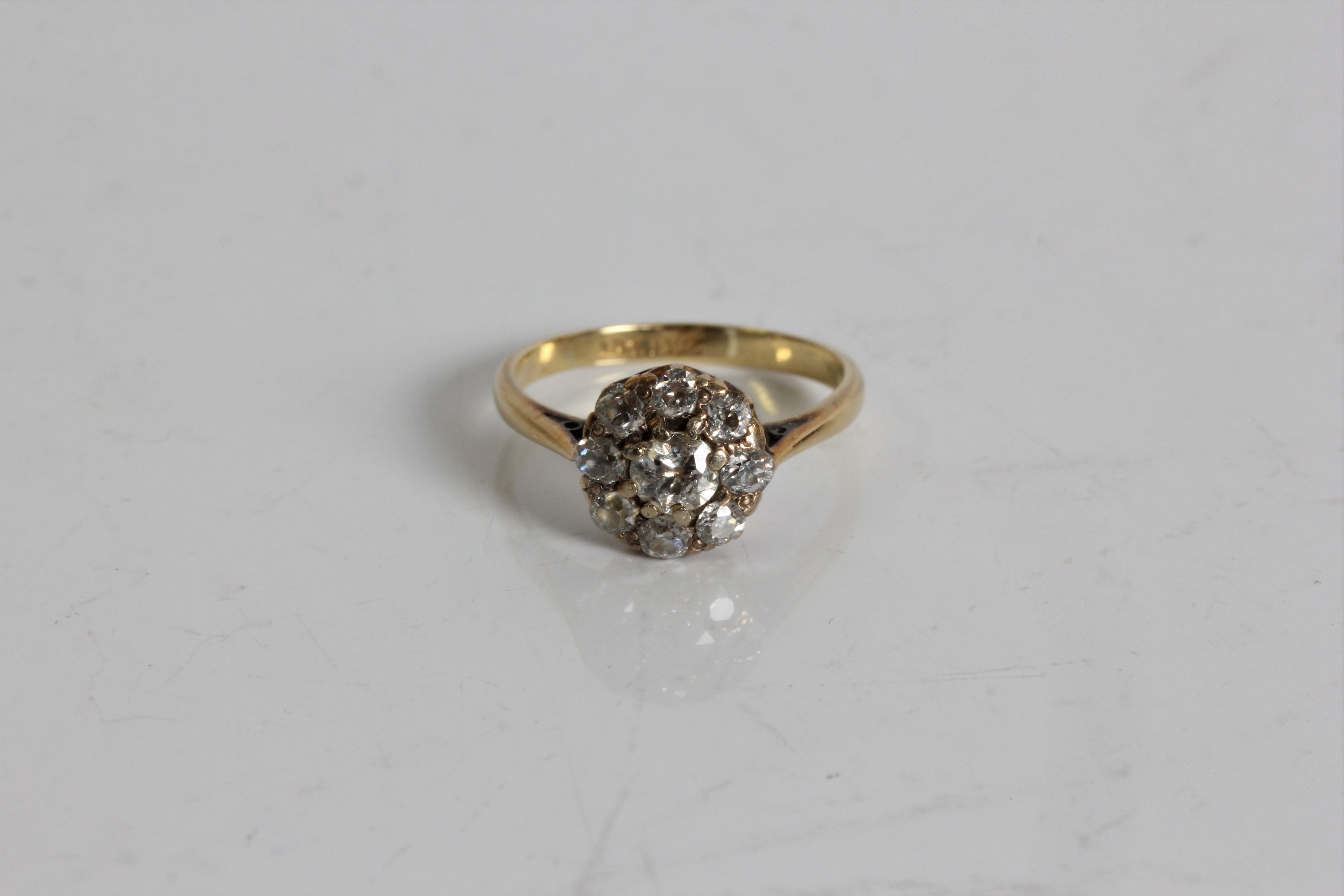 A yellow gold diamond cluster ring, marked 18ct, ring size, K 1/2, approx. weight 2.43gms. Online