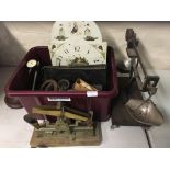 A selection of various tools including weighing scales, weights, clock face, cog, machine parts,