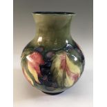 A Moorcroft grape pattern vase, signed to base, height 20cm. IMPORTANT: Online viewing and bidding