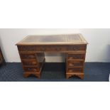 A reproduction yew wood desk with brown leather insert top. IMPORTANT: Online viewing and bidding