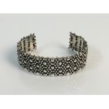 *A silver bangle 2cm in dotted and pierced design, weight 65gms. IMPORTANT: Online viewing and