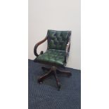 A reproduction mahogany green leather swivel armchair. IMPORTANT: Online viewing and bidding only.