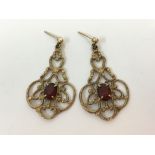 A pair of 9ct yellow gold and red gemstone dropper earrings stamped 375, approx. weight 3.8gms.