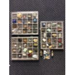 A collection of approximately 61 various gemstones in three cases with two bottles of additional