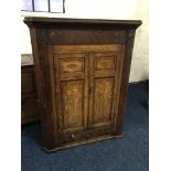 A 19th oak and mahogany two door wall mounted corner cupboard with single drawer to base. IMPORTANT: