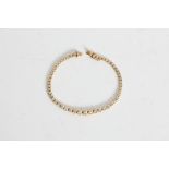 A yellow gold marked 750 graduated diamond tennis bracelet, approx. weight 9.65gms, approx. length