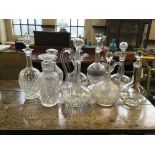 Nine various cut and moulded glass decanters with stoppers. IMPORTANT: Online viewing and bidding