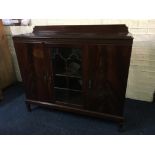 A mahogany glazed single door and two cupboard doors to side raised sideboard. IMPORTANT: Online