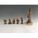 Six Geoebel figurines including lamp with girl on tree branch above dog, boy in hat and scarf,
