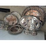 A selection of silver plate including six candlestick holders and four trays. IMPORTANT: Online