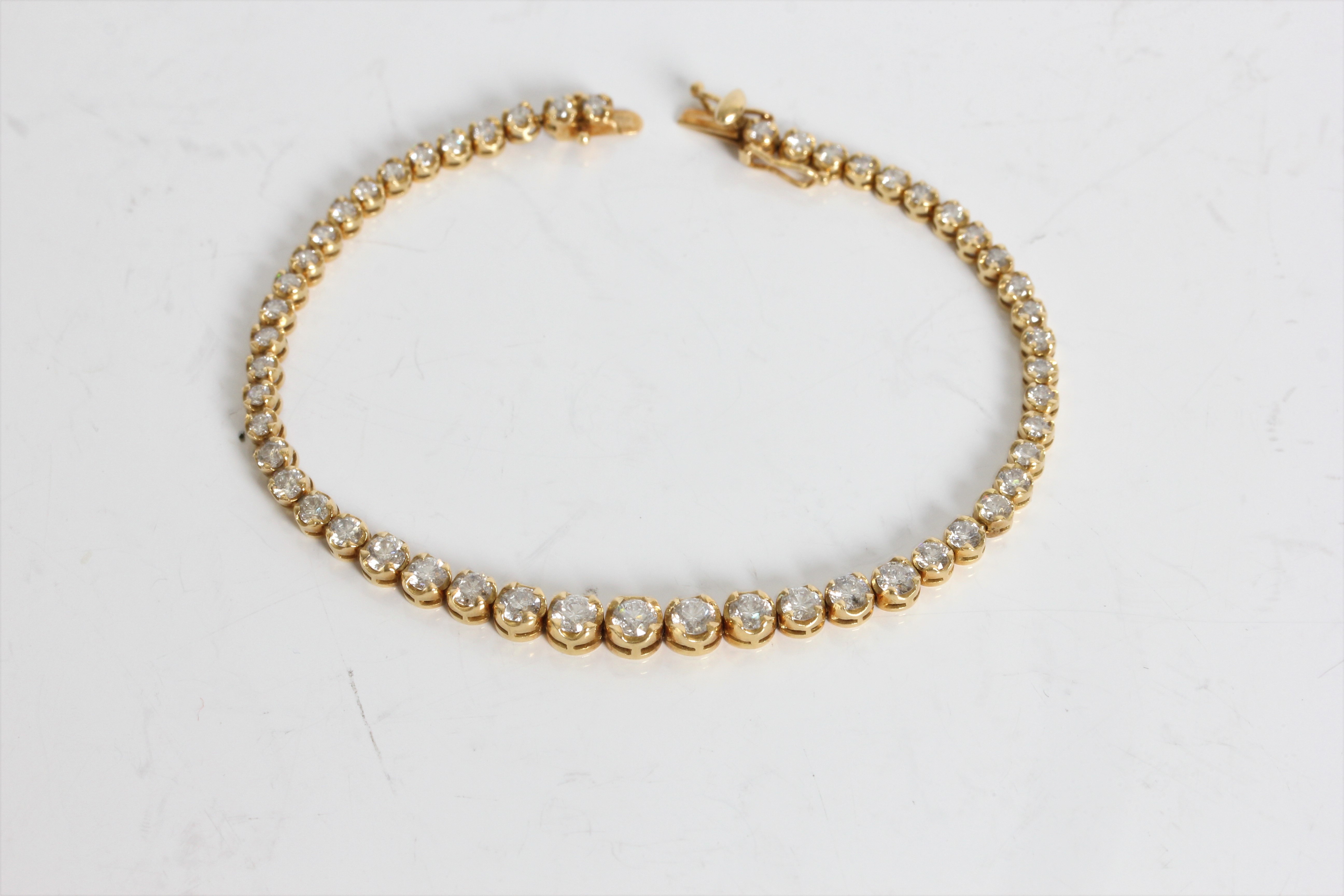 A yellow gold marked 750 graduated diamond tennis bracelet, approx. weight 9.65gms, approx. length - Image 5 of 5