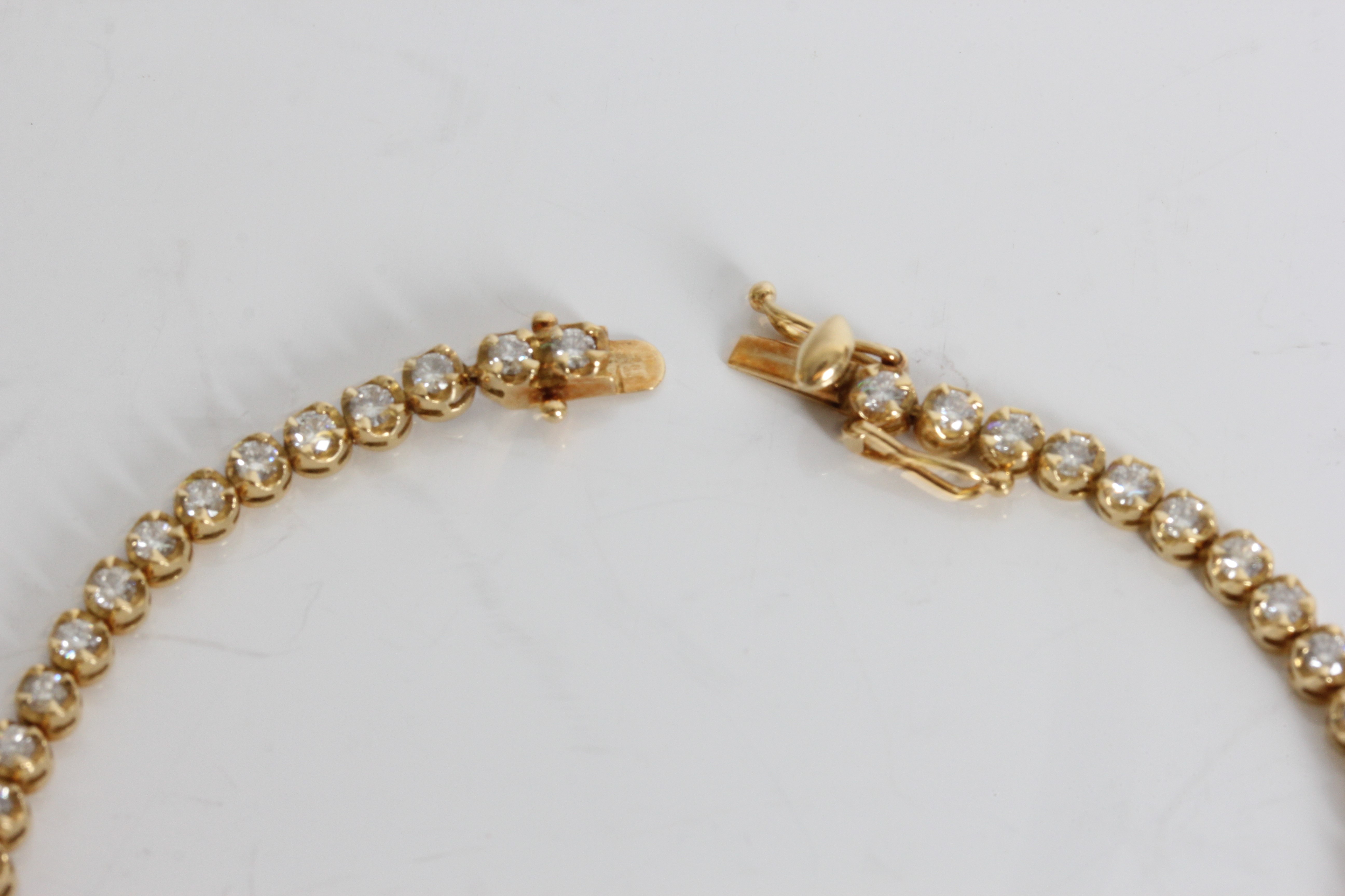 A yellow gold marked 750 graduated diamond tennis bracelet, approx. weight 9.65gms, approx. length - Image 2 of 5