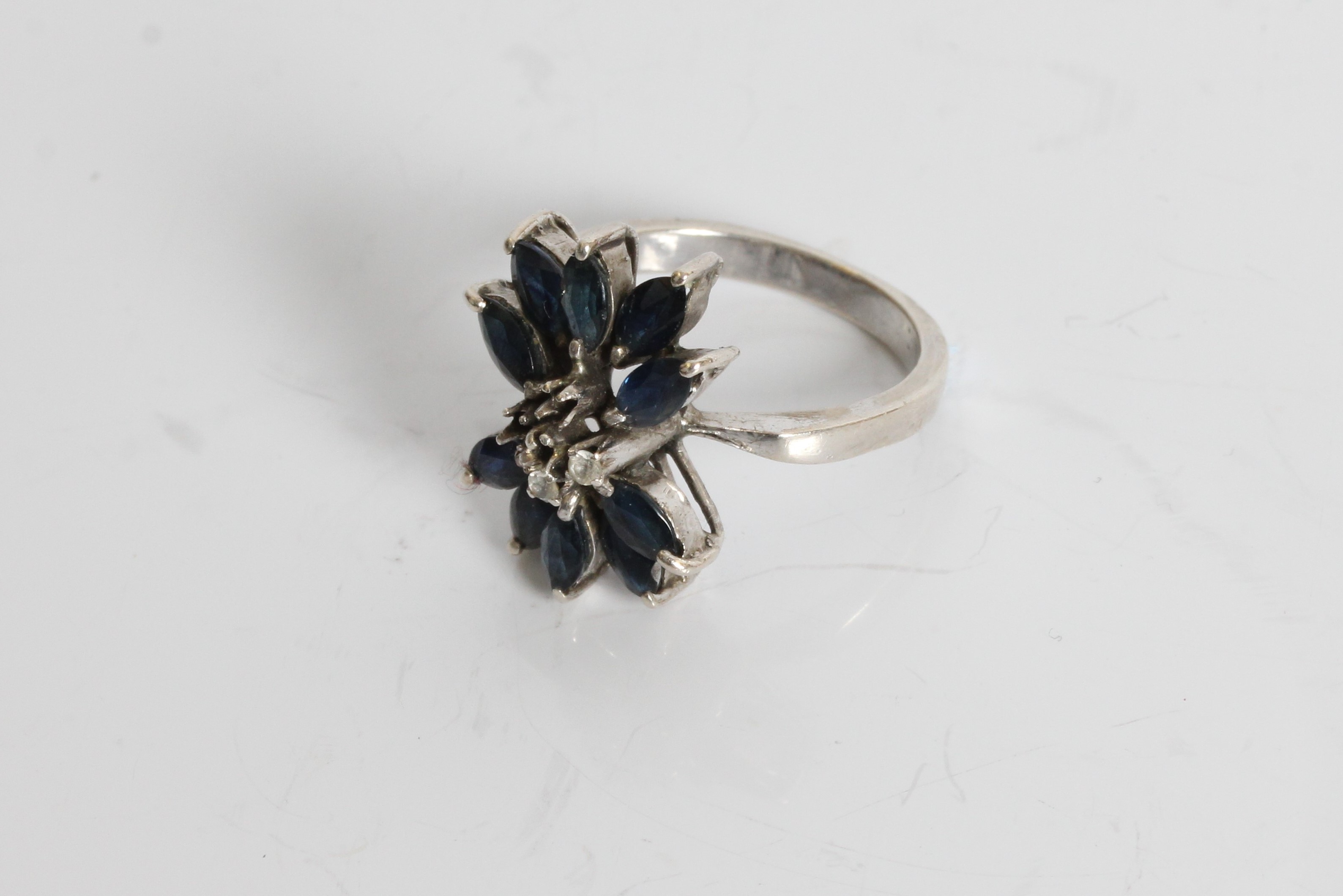 A white gold sapphire and diamond chips ring in design of a flower with petals , marked 18k, ring - Image 3 of 3