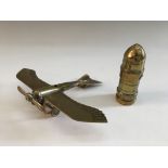 A Trench art lighter and model airplane. IMPORTANT: Online viewing and bidding only. No in person