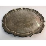 A silver tray on four feet, diameter 31cm, approx. weight 910gms. Online viewing and bidding only.