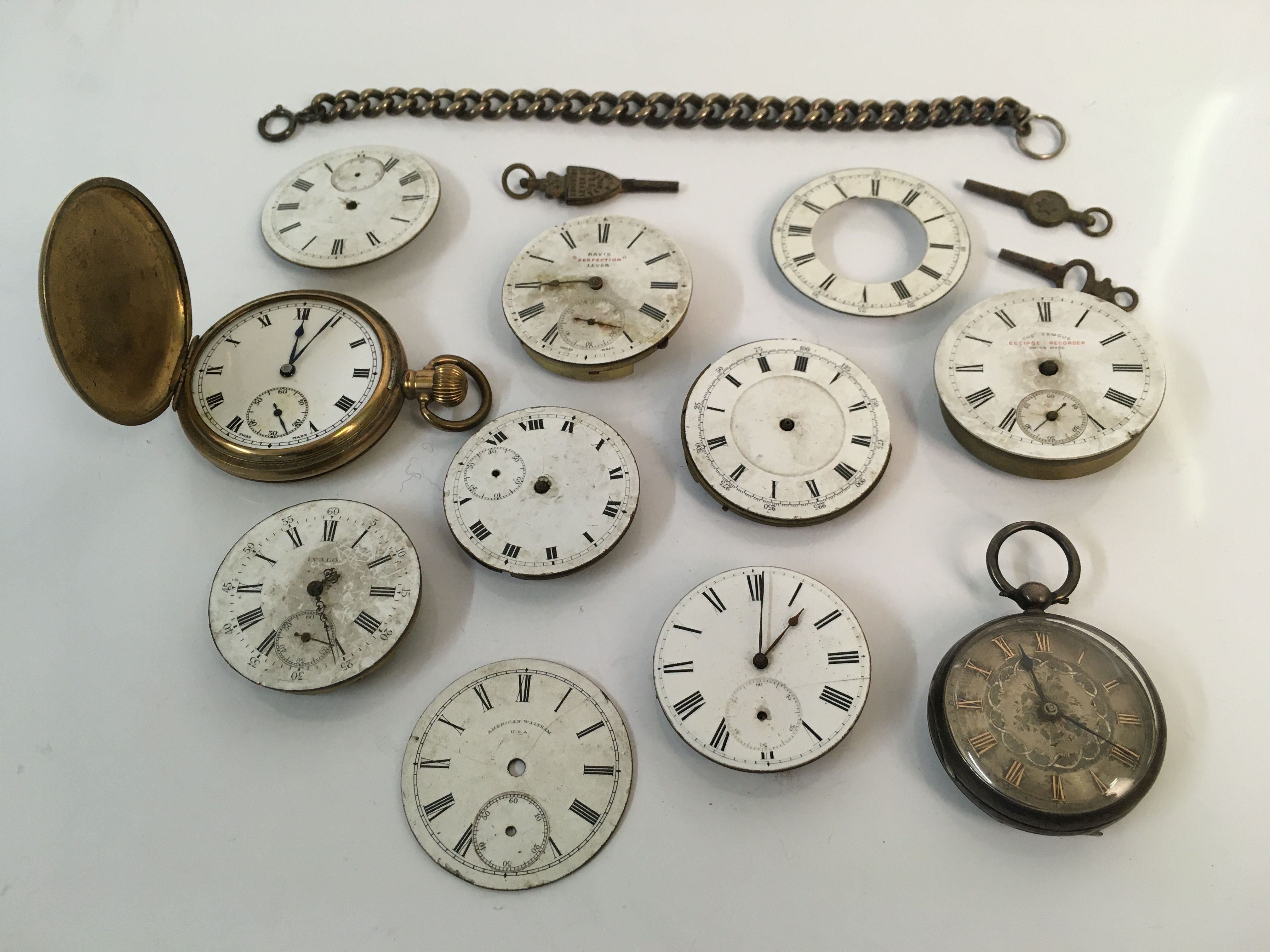 Two pocket watches together with a selection of watch faces, a chain and other parts. Online viewing