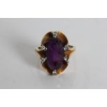 A yellow gold amethyst and diamond chips ring, marked 750, ring size J 1/2, approx. weight 7.