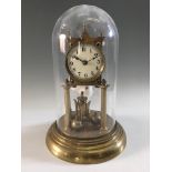 An anniversary clock on brass base with dome, height 29cm. IMPORTANT: Online viewing and bidding