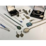 A selection of silver jewellery to include dragonfly brooch, bracelet and pendant on chain with blue