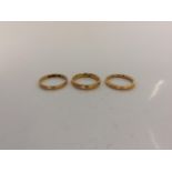 Three 22ct yellow gold wedding band rings, two ring size M, one ring size N, approx. total weight
