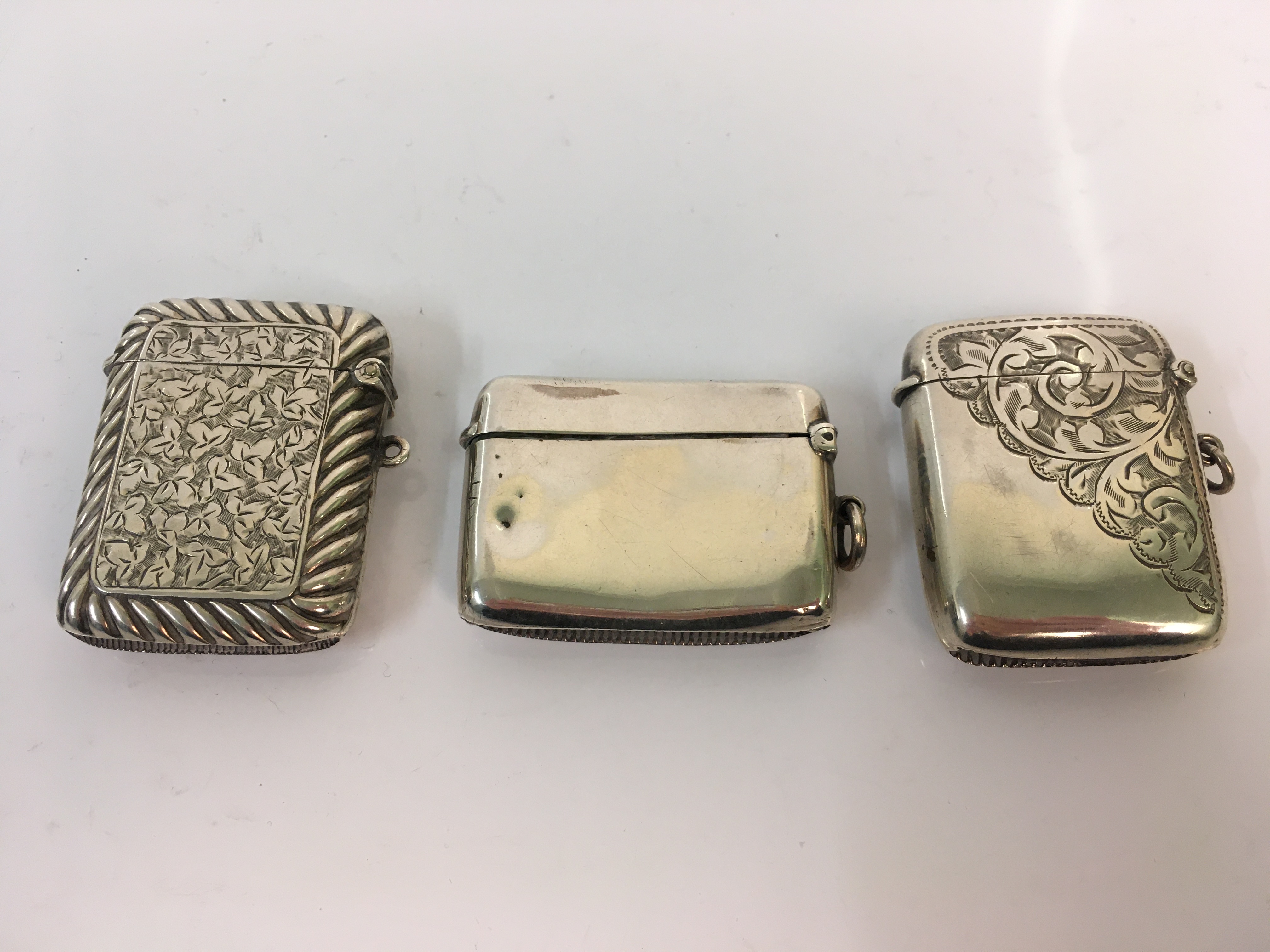 Three silver vesta cases, approx. total weight 90gms. Online viewing and bidding only. No in