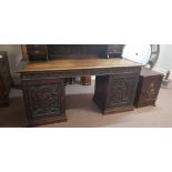 An oak carved decorated two cupboard drawers desk/sideboard. IMPORTANT: Online viewing and bidding