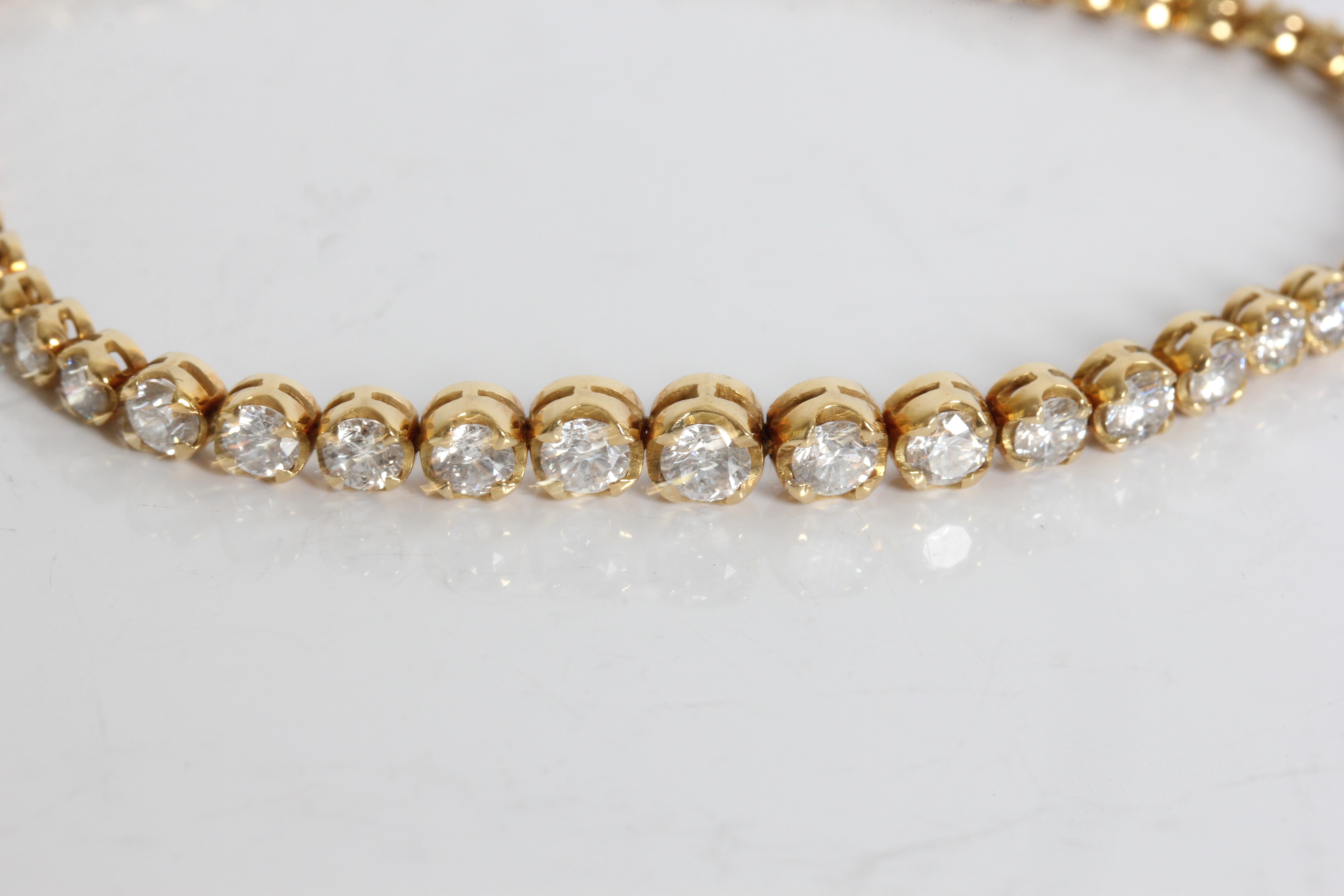 A yellow gold marked 750 graduated diamond tennis bracelet, approx. weight 9.65gms, approx. length - Image 3 of 5