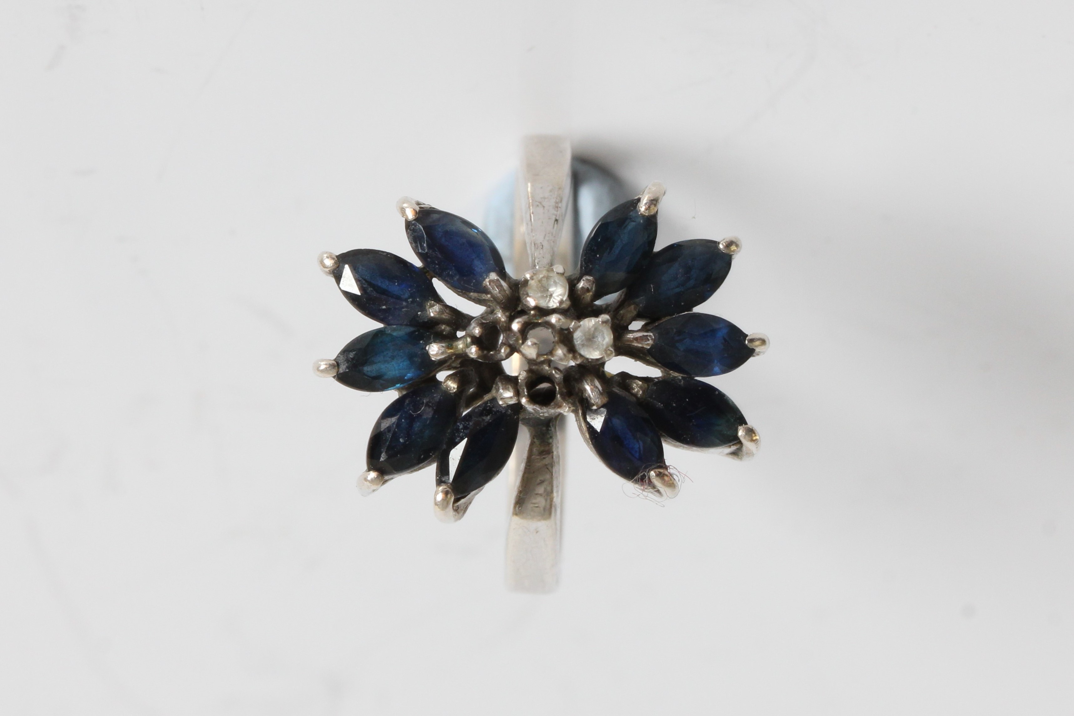 A white gold sapphire and diamond chips ring in design of a flower with petals , marked 18k, ring - Image 2 of 3