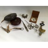 A selection of various tools including two leather cased tape measures, proportional dividers, small